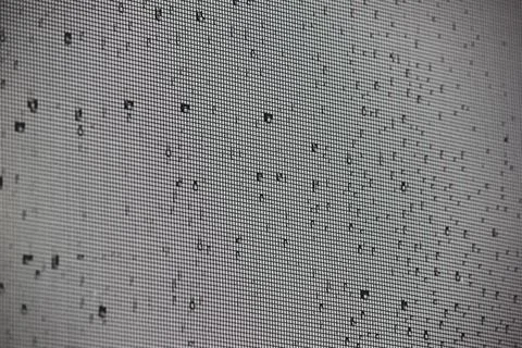 Macro view of fine window mesh grid texture with scattered water drops Stock Photos