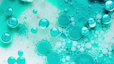 Macro view of floating ink and oil bubbles in vivid blue liquid abstract pattern Stock Footage 307386865
