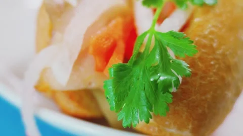 Macro view of fresh cilantro leaf on Vietnamese banh mi sandwich Stock Footage 338204099