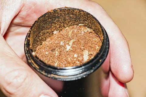 Macro View of Fresh Coffee Grounds in Manual Grinder Stock Photos
