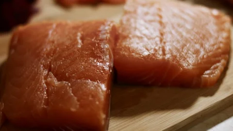 Macro view of fresh salmon fillet on a wooden board ready to be prepared. 4K Stock Footage 144899342