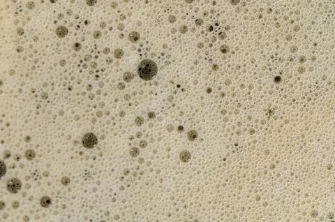 Macro View of Frothy Coffee Bubbles in Ceramic Mug Stock Photos