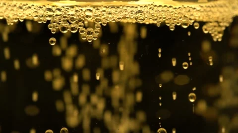 Macro view of a glass of champagne. Bubbles of carbon dioxide float up to for Stock Footage 171276318
