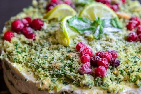 Macro view on green cake with spinach and red cranberries on a plastic food t Stock Photos