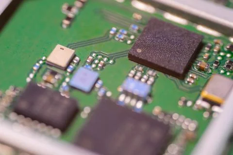 Macro view of green electronic circuit board with black integrated chips, m.. Stock Photos