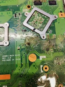 A macro view of a green laptop computer motherboard showing severe rust, 스톡 사진