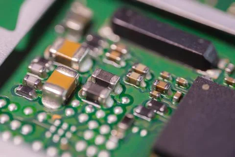 Macro view of green printed circuit board with metallic electronic componen.. Stock Photos
