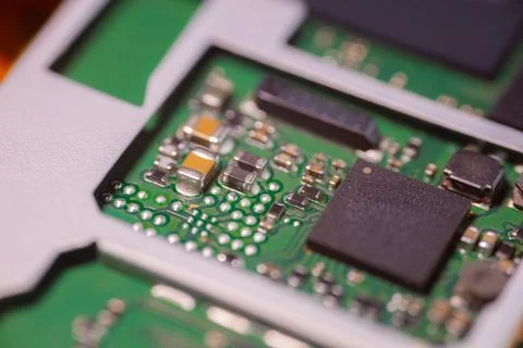 Macro view of green printed circuit board with black integrated chips, silv.. Stock Photos
