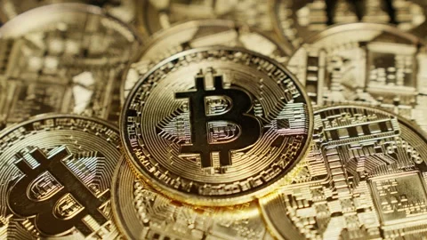 Macro view of hand placing Bitcoin on digital coin stack, symbolizing wealth Stock Footage 312030827