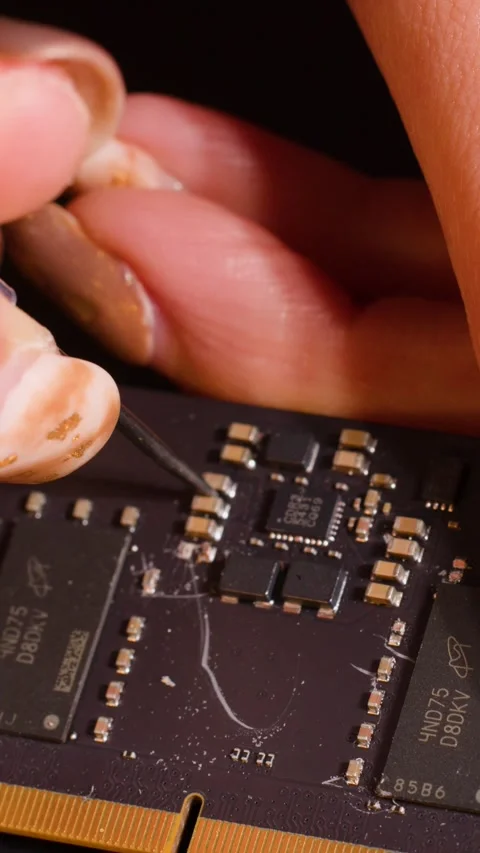 Macro View of Hand Scraping Components Off a Computer RAM Module Video stock 328391731