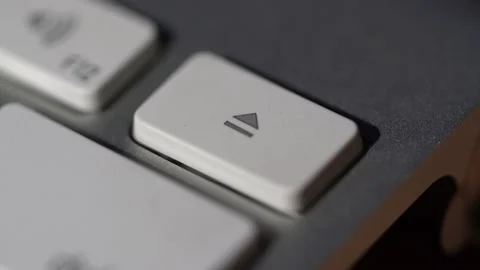Macro view of Human finger pressing a eject key on the computer keyboard Vídeos de archivo 136553948
