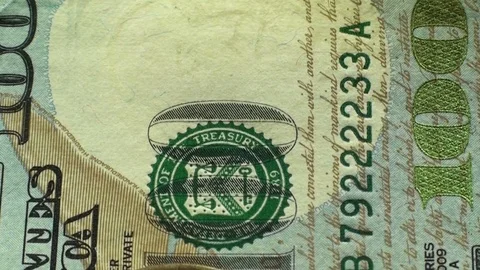 Macro view of a hundred dollar bills and coin of one dollar. Stock Footage 81775514