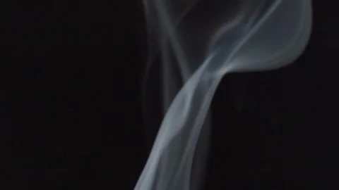 Macro View of Incense Smoke Curling Through Dark Space in Abstract Formation Stock Footage 339755973