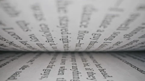 Macro view inside book slide dolly shot. Close-up text printed in english Stock Footage 144225647