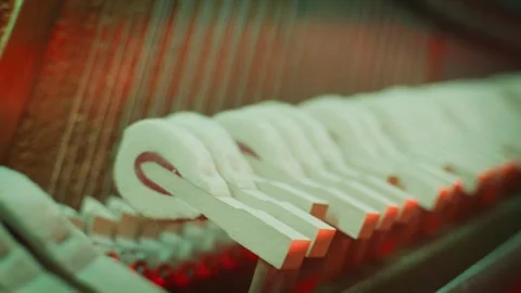 Macro View Inside a Piano with Felt Hammers Striking Strings Stock Footage 332144913