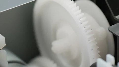 Macro view inside a working printer, plastic gears spinning. Stock Footage 276819449