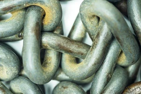 Macro view of interconnected, weathered steel chain links showing rust, wea.. Stock Photos