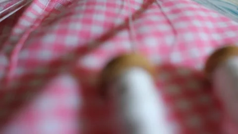 Macro view of intricate bobbin lace pattern and wooden crafting bobbins 库存影片 332299052