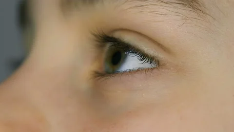 Macro view of kid eye detail while watching tv,eyes blinking slowmotion 4k Stock Footage 230983017