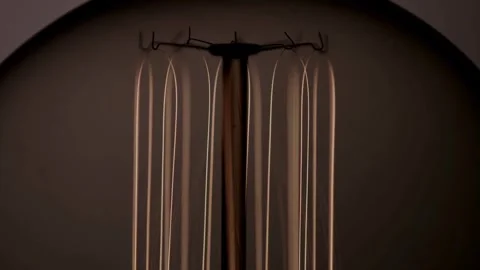 Macro view of light bulb filaments glowing intensely bright Stock Footage 329657258