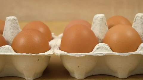 Macro view. Lots of fresh raw chicken eggs in cardboard boxes, dolly shooting Stock Footage 154180287
