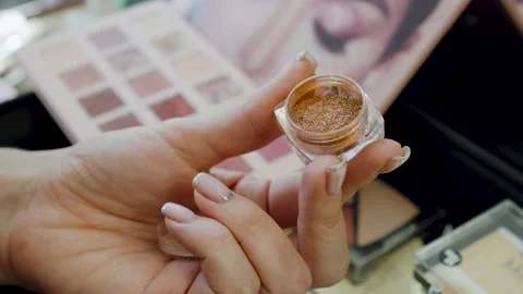 Macro view of makeup artist working with eyeshadow palette. Finger gains glitter Stock Footage 150588070