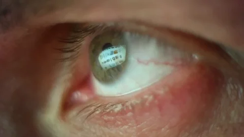Macro view of man's eye with lashes. Reflection of different pisctures of goods Stock Footage 124861543