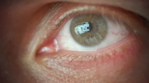 Macro view of man's eye with lashes. Reflection of different pisctures of goods Stock Footage 124861671