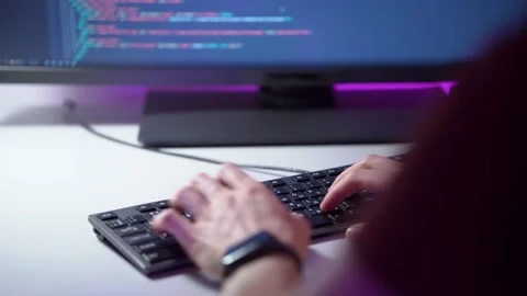 Macro view of mans hands who is typing on keyboard and coding a program on a Stock Footage 152720106