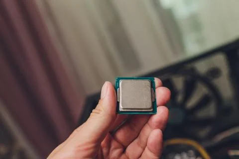 Macro view of modern multicore CPU processor in human hand with PC computer 写真素材