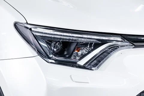 Macro view of modern white car xenon lamp headlight Stock Photos