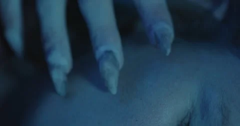 Macro view of a Monster claw touching a sleeping woman's cheek Stock-Footage 253398710