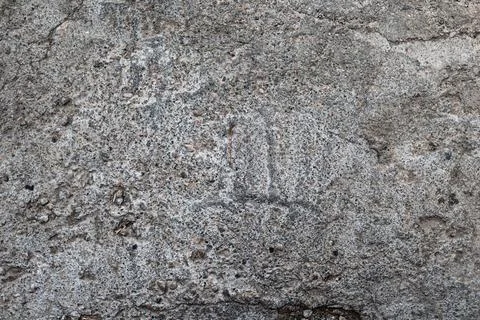 Macro view of an old gray concrete wall with surface pitting, erosion marks Stock Photos