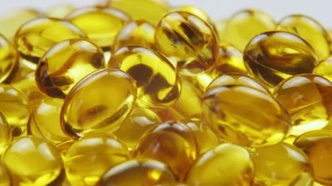 Macro view omega 3 gold fish oil capsules, rotation background Stockbeeldmateriaal 155139684
