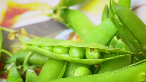 Macro View of Open Green Pea Pod with Fresh Seeds Inside and Small Worm Vídeos de archivo 336974795