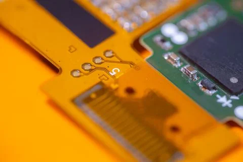 Macro view of orange electronic circuit board with gold contacts, printed n.. Stock-Fotos