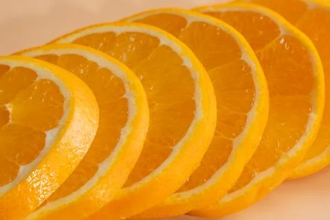 Macro view of overlapping orange slices with glossy pulp. Stock Photos