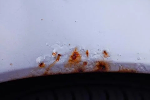 Macro view of oxidized area on silver automobile wing Stock Photos