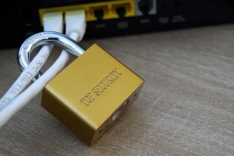 Macro view of a padlock locking ethernet cables on router Stock Photos