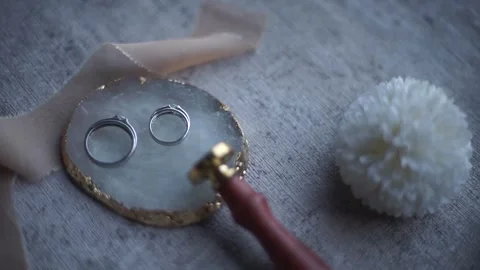 Macro View of Pair of Gold Wedding Bands and Engagement Ring Stock Footage 341102681