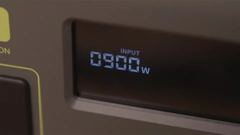 Macro view of power station display showing 1100W fast charge input 스톡 동영상 347069005