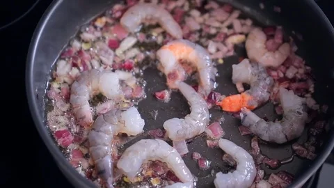 Macro view of process of frying chopped onion and shrimp in iron pan Stock Footage 72136173