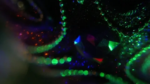 Macro view of purple shiny ball lighted by colorful garland on the Christmas Video stock 101063699