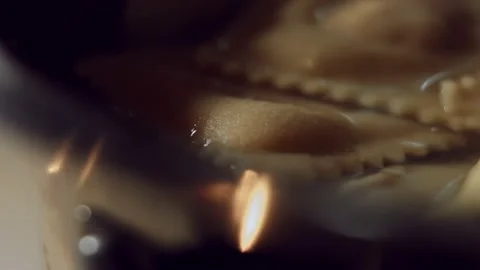 Macro view of ravioli cooking in a pan with hot water. Preparing ravioli, a Stock Footage 144833371