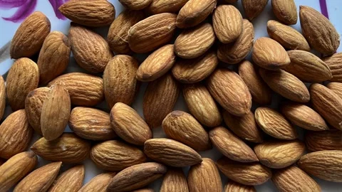 Macro view of raw organic almonds on a white decorative plate Stock-Footage 328441255