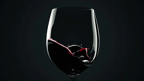 Macro view of Red wine is poured from bottle into a glass with splash on black Stock Footage 149302945