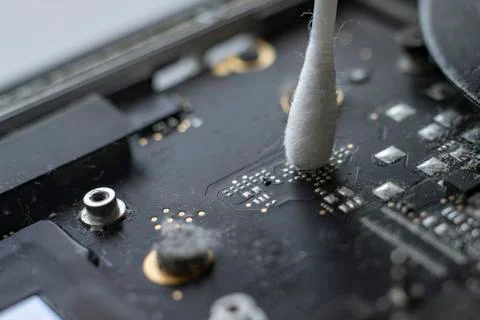 A macro view of removing dust from microprocessor board using the cotton bud Stock Photos