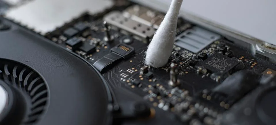 A macro view of removing dust from microprocessor board using the cotton bud 写真素材