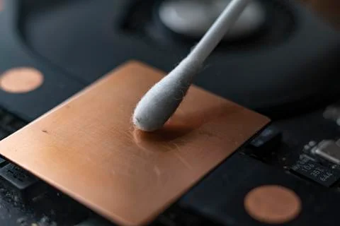 A macro view of removing dust from microprocessor board using the cotton bud 스톡 사진