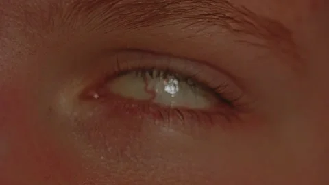 Macro view of rolled backwards eyeball turning back and looking into camera Stock Footage 258432270